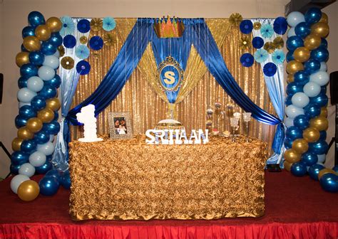 Birthday party background with gift boxes and party hats on wood. Baby Boy 1st birthday decor at Aachi's indian restaurant ...