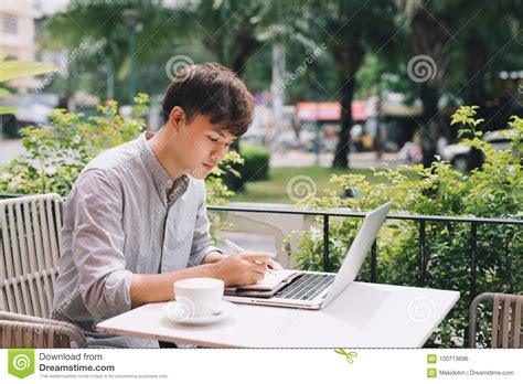 Young Male Freelancer Working With Laptop Computer In