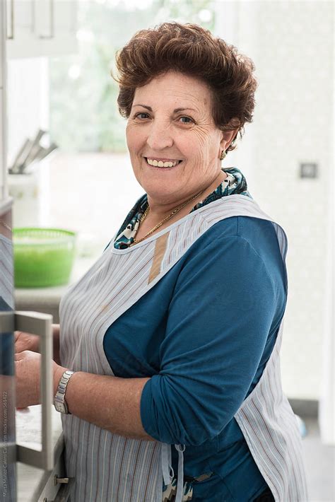 Mature Spanish Woman With An Apron In The Kitchen By Marta Muñoz Calero