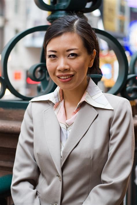 An Asian Woman Dressed In Business Attire In The City Royalty Free