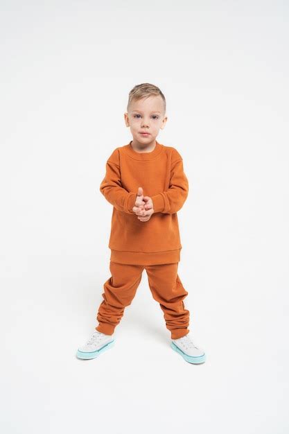 Premium Photo The Boy Stands In A Tracksuit A Child In Monochromatic