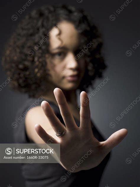 Woman Reaching Hand Toward Camera Superstock