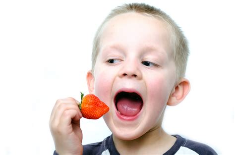 Happy Little Boy Eats Strawberries Free Stock Photo Public Domain