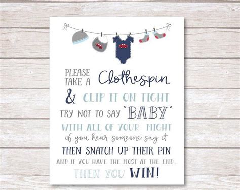 A Printable Baby Shower Sign With Clothes Hanging On A Line And The