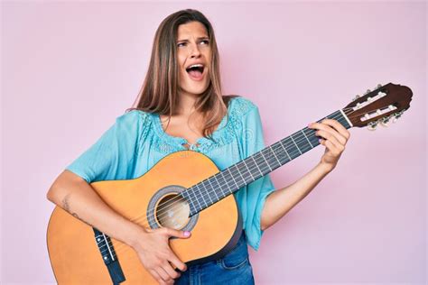 Beautiful Caucasian Woman Playing Classical Guitar Angry And Mad