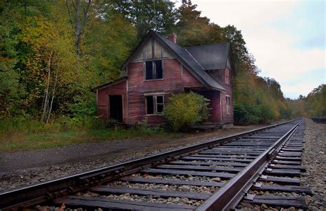 Abandoned Train Station On Railroad Tracks