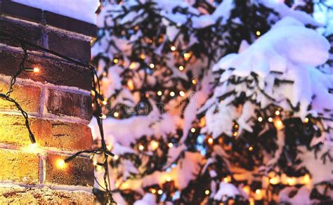Brick Wall Christmas Background With Lights Glowing And Snow Stock