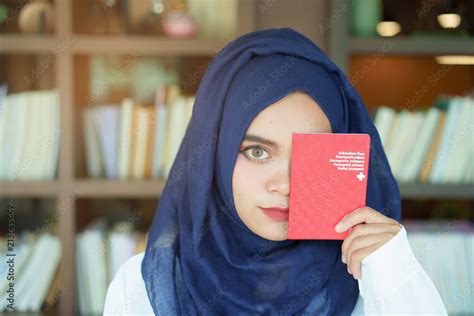 Muslim Girl Showing A Swiss Passport Book With A Happy Face Stock