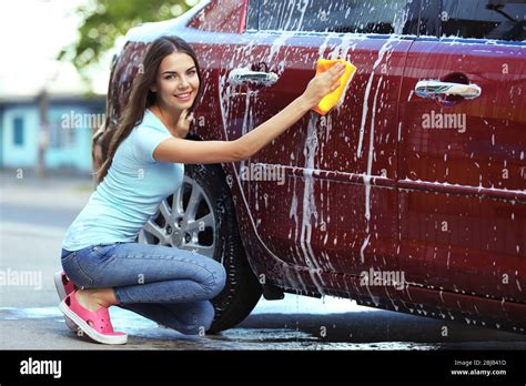 Woman washing a car Stock Photo - Alamy