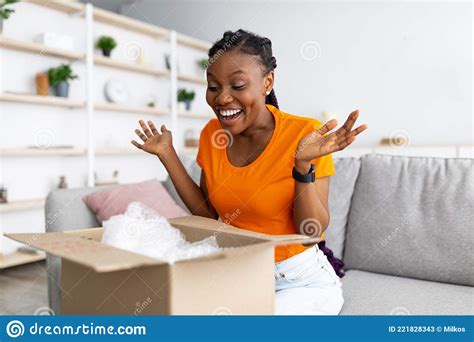 Satisfied Female Client Opening Cardboard Box Excited Over Great
