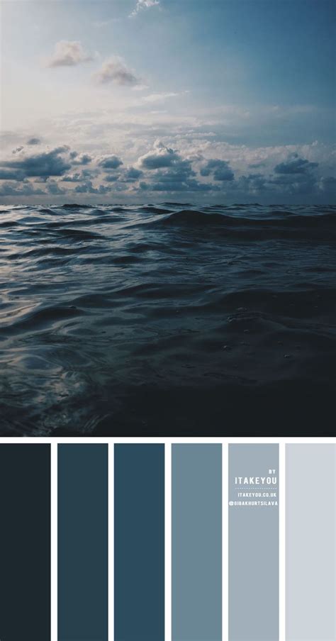 The Ocean Is Full Of Blue And Gray Hues With Some Clouds In The Background