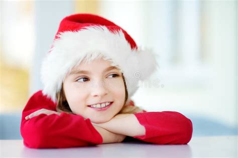 Adorable Little Girl Wearing Santa Hat On Christmas Morning Stock Photo