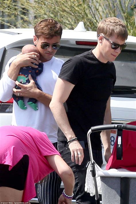 Is he dead or alive? Tom Daley and Dustin Lance Black pictured with newborn son ...