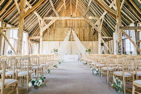 The bridge is over top of a river that flows all around the entire ceremony point. Clock Barn Gallery | Rustic wedding venue Hampshire