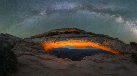 Milky Way Galaxy Panorama Over A Lit Mesa Arch In Canyonlands National