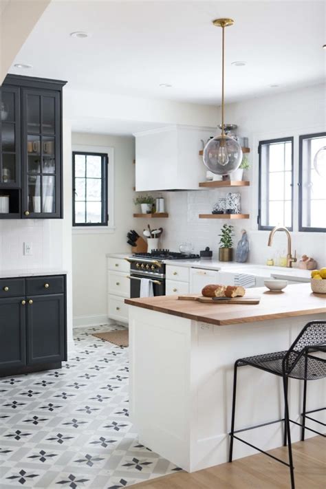 If your flooring is uneven, adjust the legs of your cabinets until they are level before fully installing. Charming Black, White and Brass Kitchen Renovation