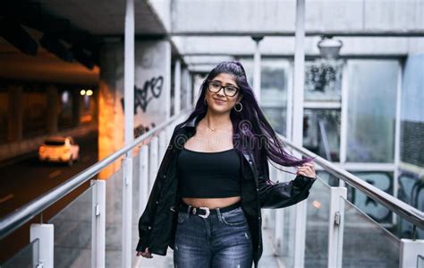 Latina Girl With Glasses Brunette Fur Jacket Long Hair Round Earrings Lip Piercing Smiling At