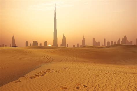 Dubai City Skyline At Sunset Seen From The Desert Stock Photo