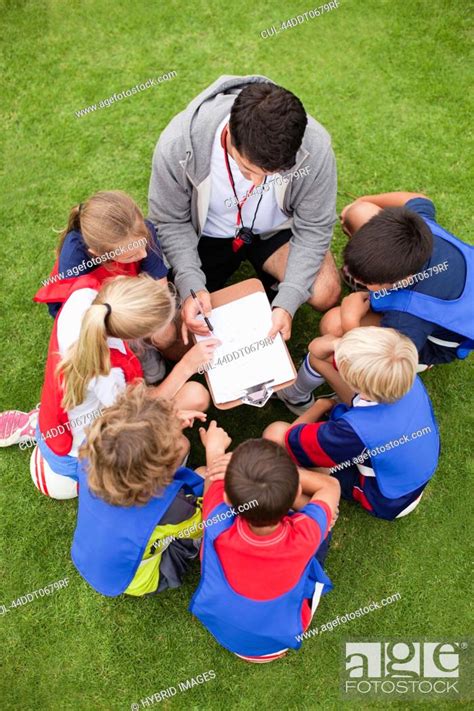 Coach Talking To Childrens Soccer Team Stock Photo Picture And