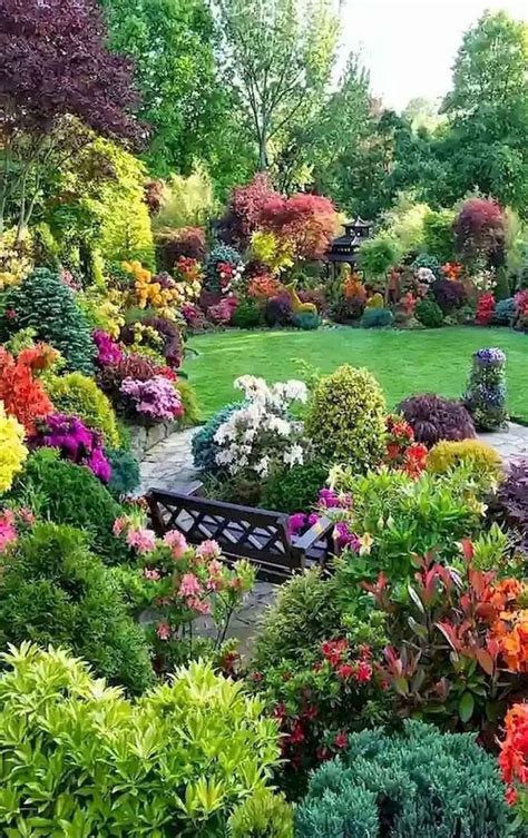 A Garden Filled With Lots Of Colorful Flowers And Greenery Next To A