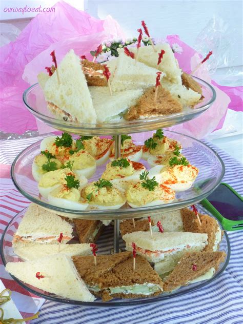 This is similar to the idea of creating a cake, sundae or cupcake out of baby supplies. Cute, small ang girly, classic baby shower food - Deviled Eggs and Cucumber and Smoked Salmon ...