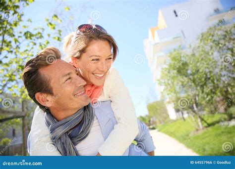 Smiling Man Carrying Woman On His Back Outdoors Stock Photo Image Of