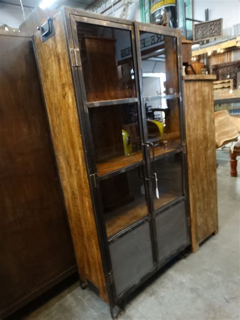 Wood Cabinet With Glass Doors Has An Industrial Rustic Flair