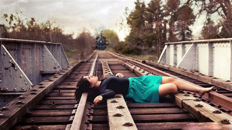 Sad Girl Lying On Railway Track