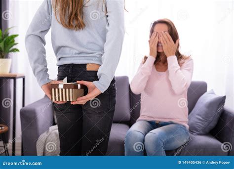 Girl Hiding Gift From Her Mother Stock Photo Image Of Girl Lady