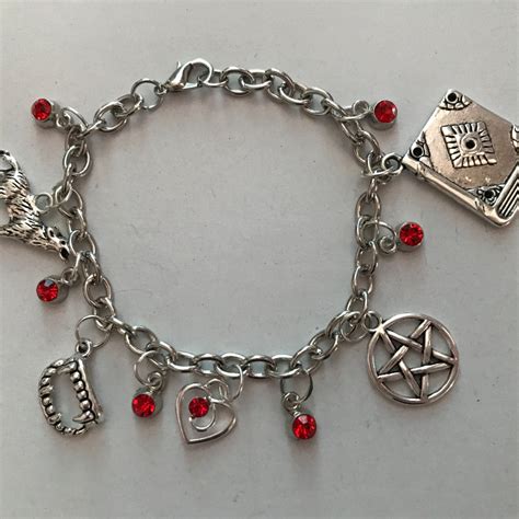 A Silver Bracelet With Charms And Symbols On It