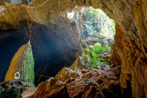Moss Covered Shrine Illuminated By Sun Rays In Saddan Cave Close To Hpa