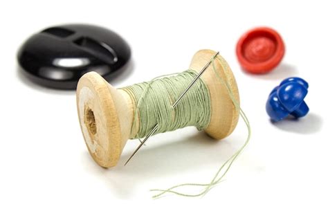Premium Photo Vintage Wooden Spool Of Green Thread Needle And Buttons