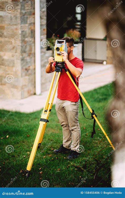 Landscaping Surveyor Engineer In Garden Elevation Working With Total