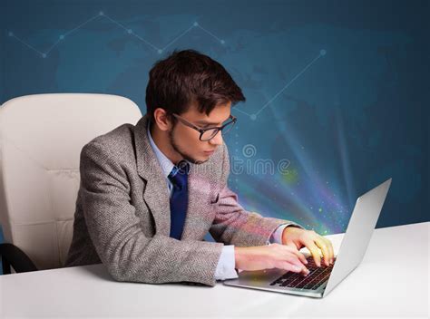 Handsome Man Sitting At Desk And Typing On Laptop With Abstract Stock
