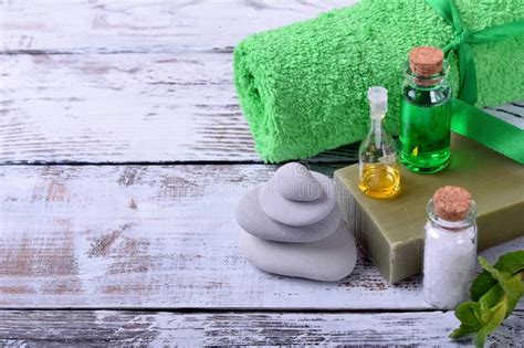 Spa Set Massage Stones Aromatic Oil Sea Salt Green Gel Organic Soap And Green Towel Stock