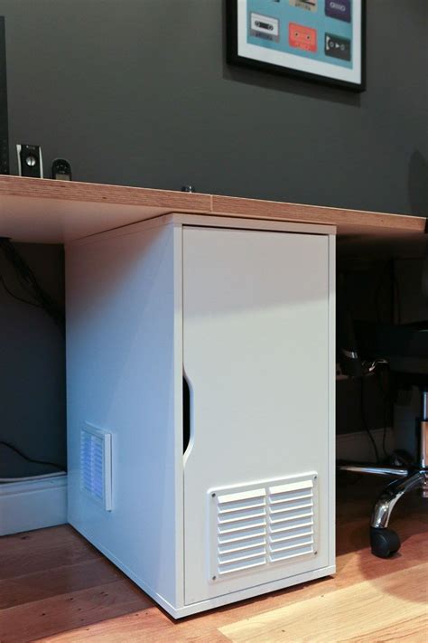 A White Computer Tower Sitting On Top Of A Wooden Floor Next To A Desk