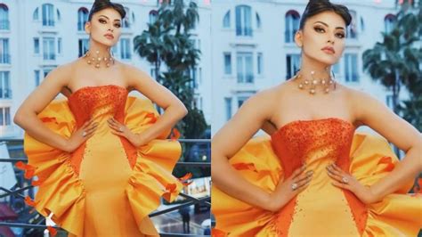 urvashi rautela stuns in orange gown at cannes film festival 2023 fans say looking like a doll