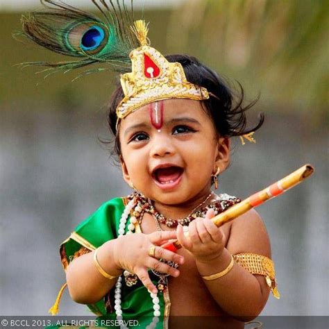 A kid dressed up as Lord Krishna before participating in fancy dress 