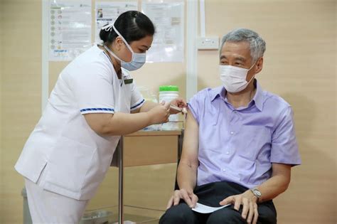 Singapore — singapore needs a suite of measures beyond covid vaccinations in order to open up. 'Please take it,' Singapore PM says after getting COVID-19 ...