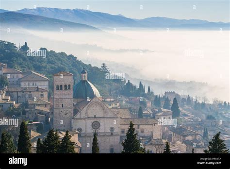 assisi in the fog and the cathedral of san rufino perugia province umbria region italy stock