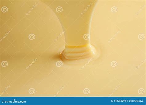 Tasty Pouring Condensed Milk As Background Dairy Product Stock Photo