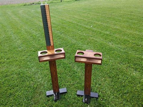 There Are Two Wooden Stands In The Grass
