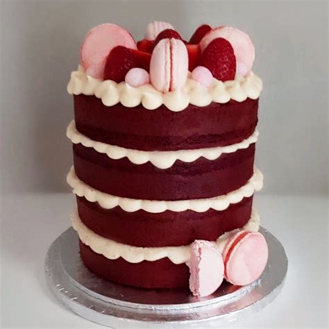red velvet cake topped with pink macarons and strawberries pink macarons cake toppings