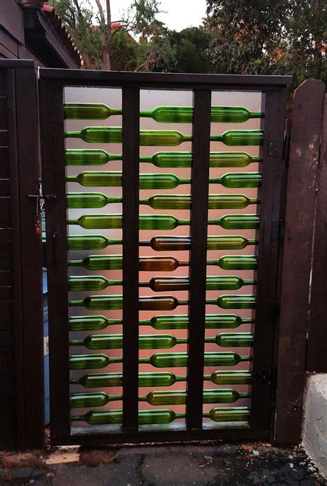Bottle Gate Gate Made With Used Wine Bottles Lighted At Night With