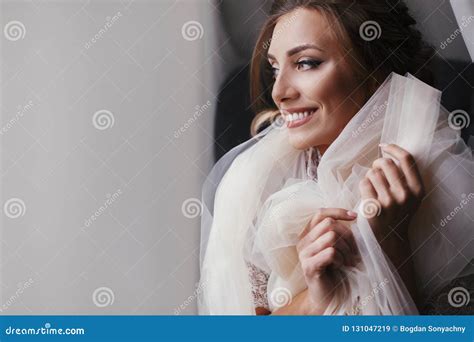 Gorgeous Beautiful Bride In Silk Robe Posing Near Window In Sof Stock