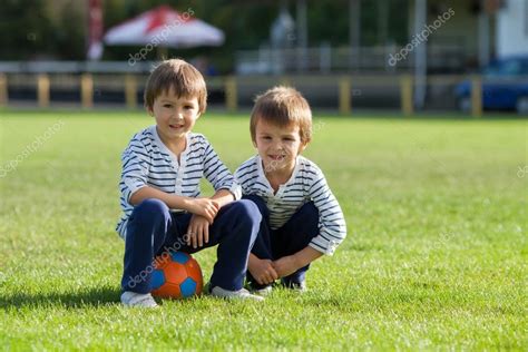 Two Cute Little Boys Playing Football — Stock Photo © Ttomsickova