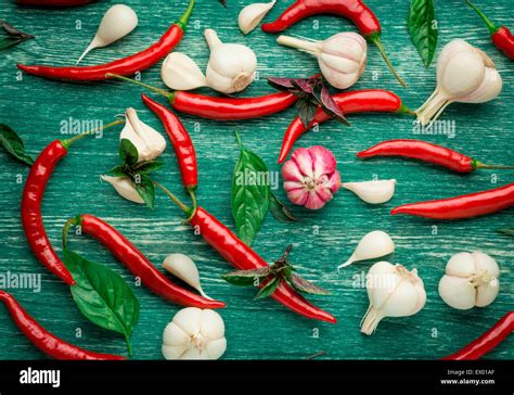 Red Hot Chili Peppers With Spice Ingredients Over Wooden Background