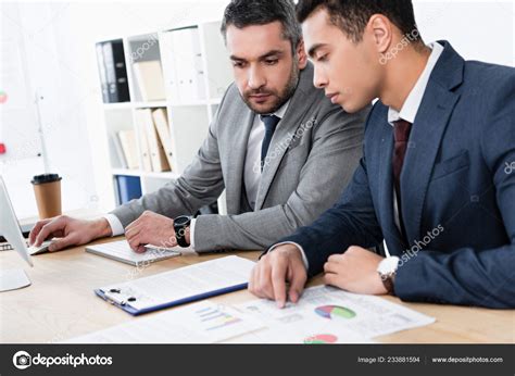 Two Concentrated Business Colleagues Working Papers Desktop Computer