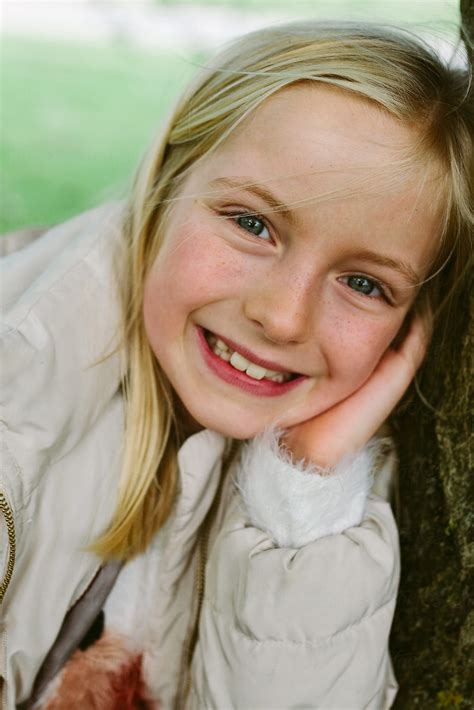 Portrait Of A Smiling Little Girl Outdoors By Stocksy Contributor
