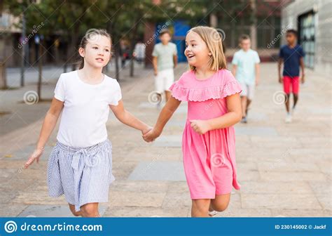 Two Girls Walking Together Outdoors Stock Photo Image Of Town Summer